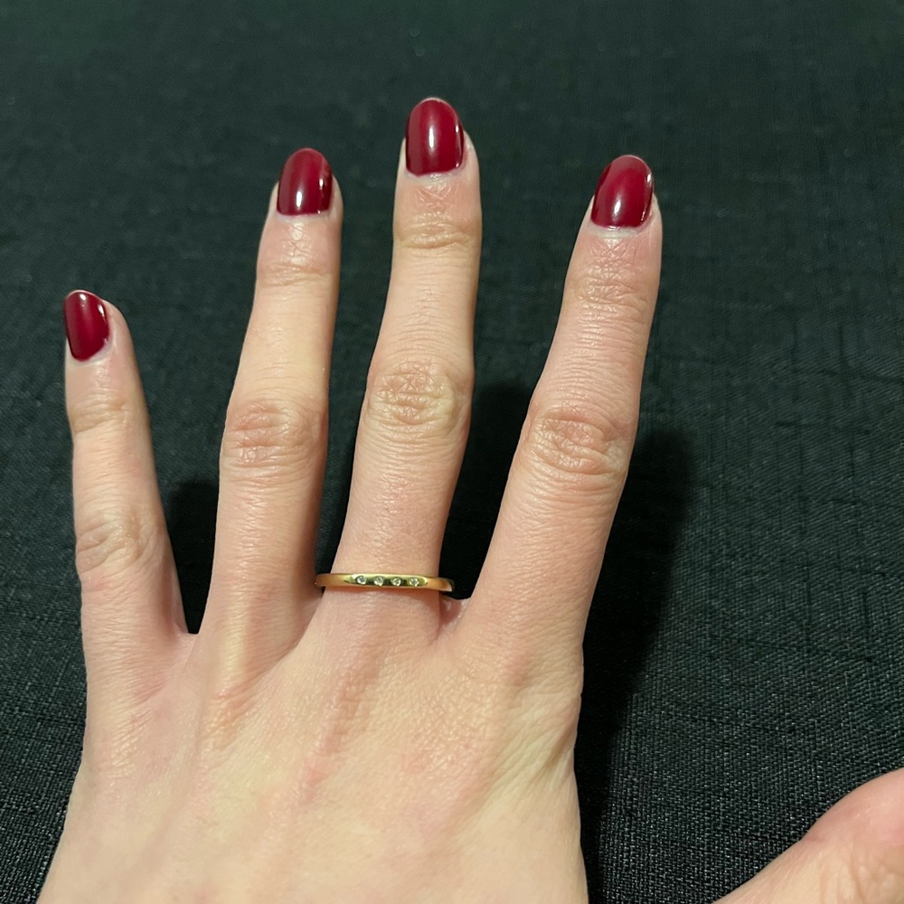 Gold-colour ring with four little stones in size 7